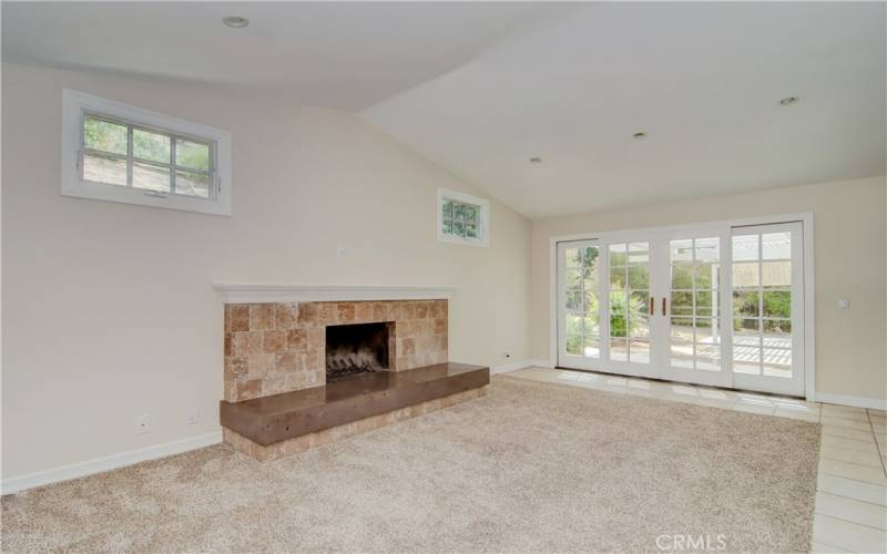 Separate, oversize family room off of the kitchen with vauled ceilings, fireplace find sliding French doors.