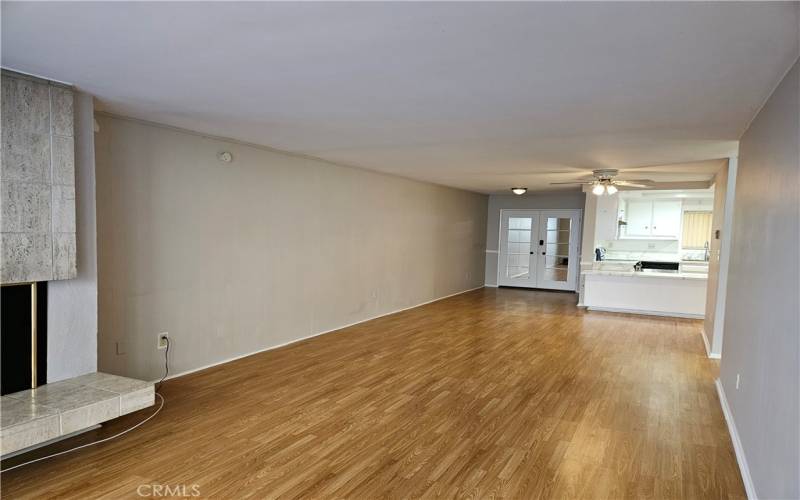 Living room to dining area to entry doors and kitchen