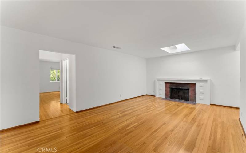 Living Room with fireplace and skylight above