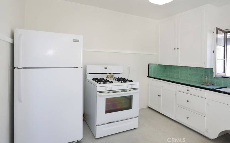 A gas range and refrigerator are included.