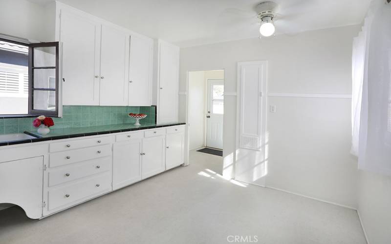 Heading towards the designated laundry room and backyard door. Did you notice the built in ironing board cabinet?