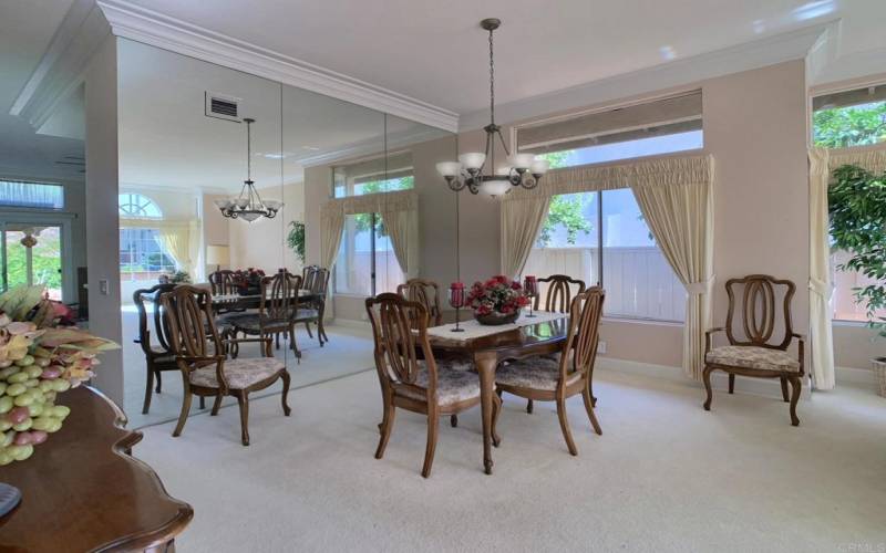 Formal Dining area with mirrored wall