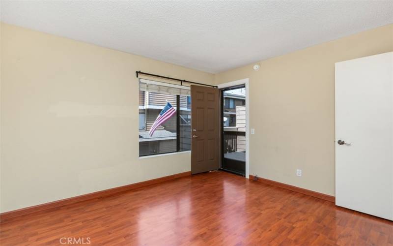 Main floor bedroom with door to balcony