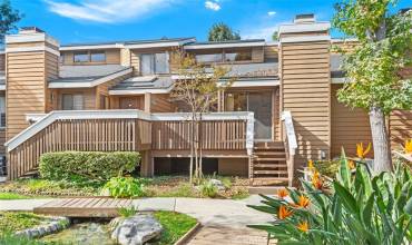 Front deck overlooks the stream and beautiful landscaped area