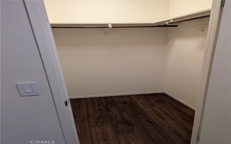 Primary bedroom walk in closet