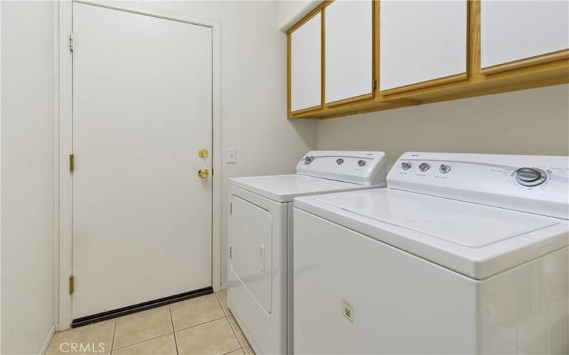 Private laundry room with cabinets