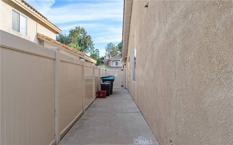 Side yard with newer vinyl fencing