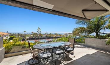 Dine al fresco on the ocean view deck adjoining the living room.