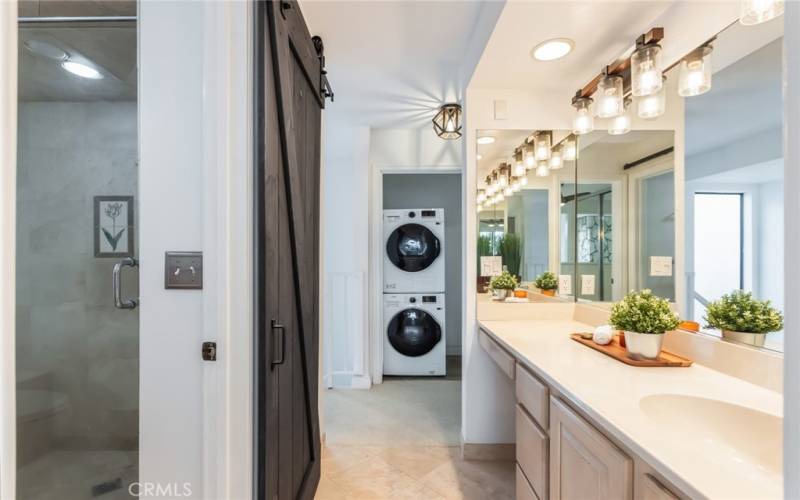 primary vanity leading to the separate shower/toilet area