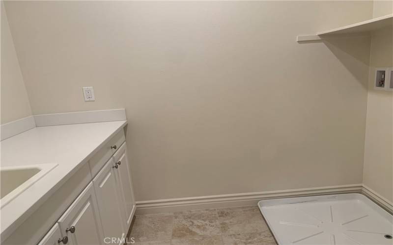 Upper level laundry room with sink