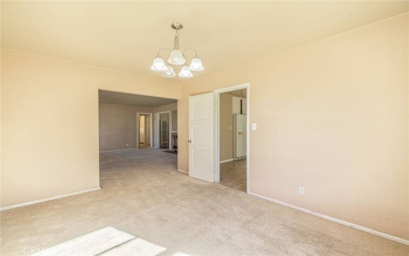 DINING SPACE VIEW INTO LIVING ROOM AND KITCHEN