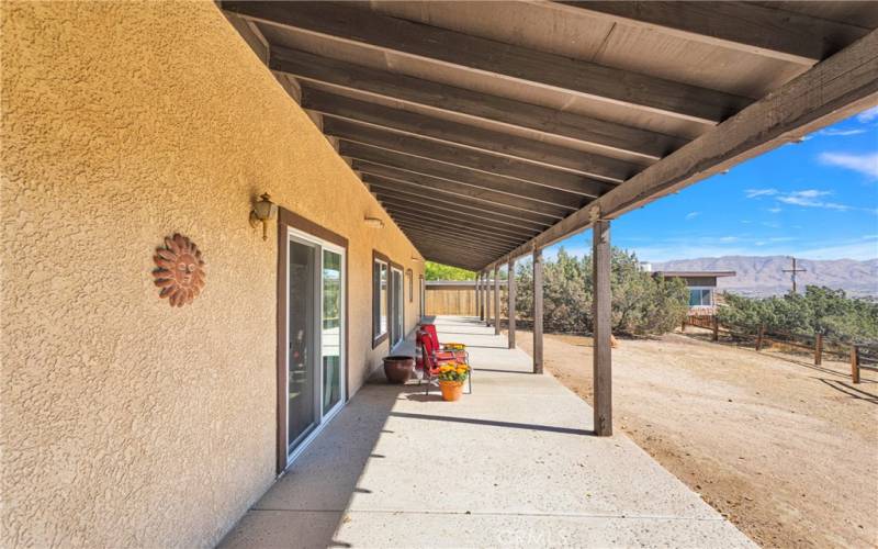 Full span covered patio overlooks the golf course and mountains without obstruction.