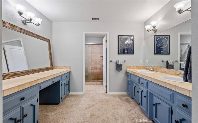 The ensuite bathroom has a glorious double sink vanity plus an additional vanity for storage or getting ready.