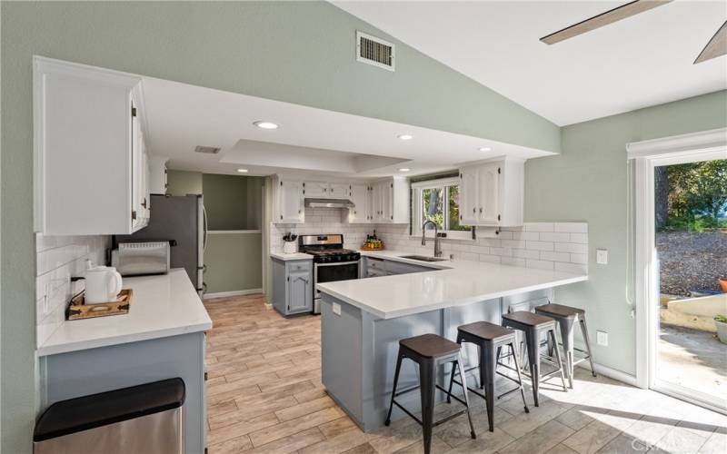 The kitchen has been thoughtfully updated with sleek quartz countertops and subway tile backsplash.