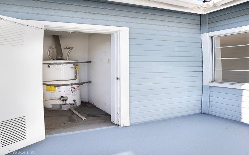 The water heater cabinet located on patio.