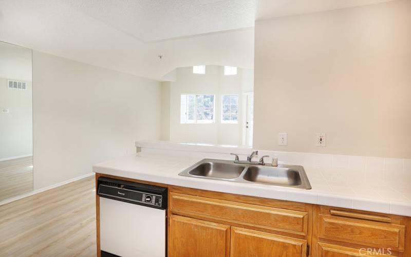 Kitchen looks out to living room and dining  area.