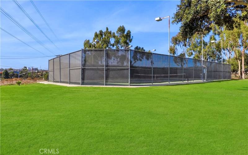 Tennis courts and grassy areas all around