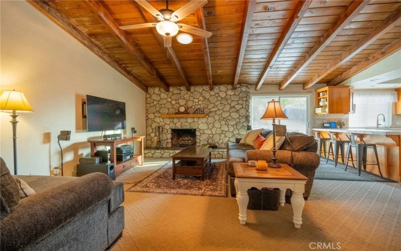 ANOTHER VIEW OF OPEN FLOOR PLAN FAMILY ROOM AND KITCHEN WITH BEAUTIFUL NATURAL WOOD BEAM VAULTED CIELINGS.