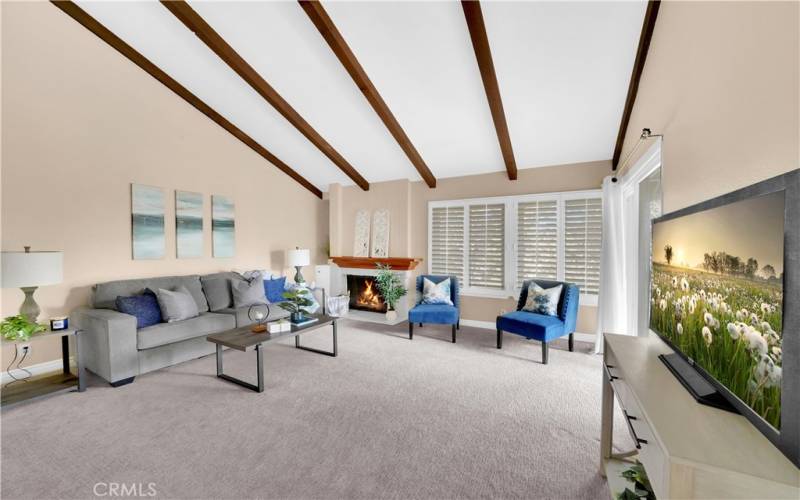 Living room with vaulted ceilings and fireplace