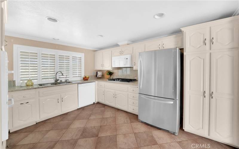 Wood Shutters and plenty of storage in this kitchen