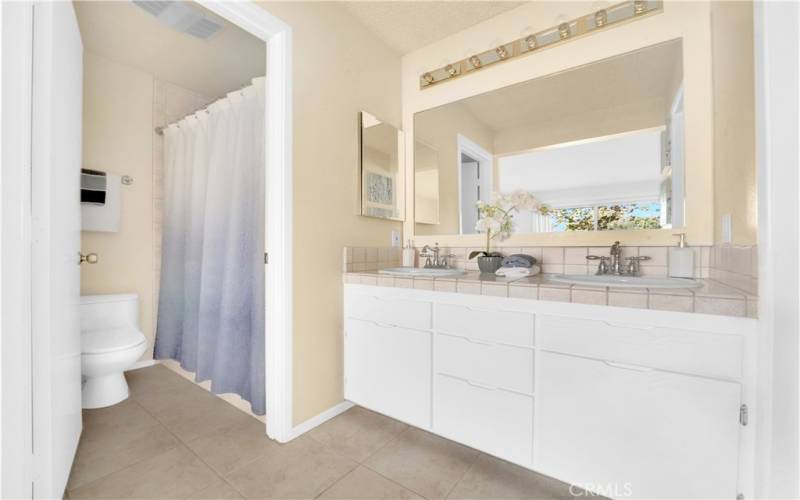 Primary bathroom with dual vanity and walk-in shower