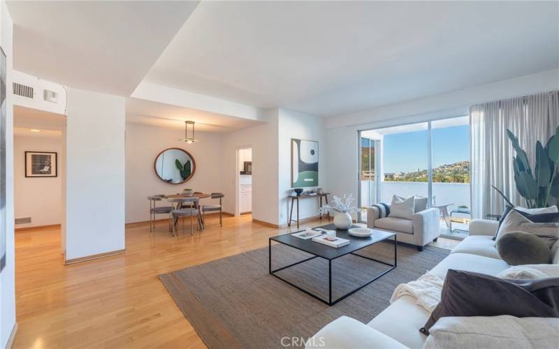 Light and airy living room and dining area to a balcony with great views!