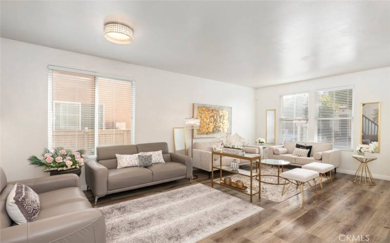 This open and airy living area is filled with natural light, creating a warm and inviting space for relaxation and entertaining.