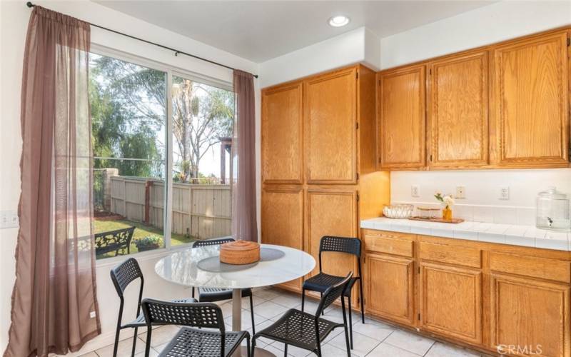 This open kitchen offers plenty of counter space, modern appliances, and a cozy dining area with views of the backyard, perfect for family meals and gatherings.