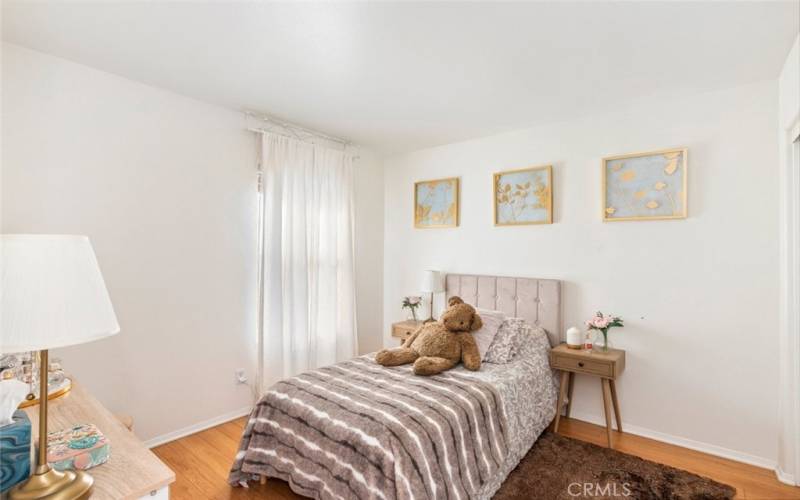 This cozy bedroom is bathed in natural light, creating a warm and inviting atmosphere perfect for relaxation.