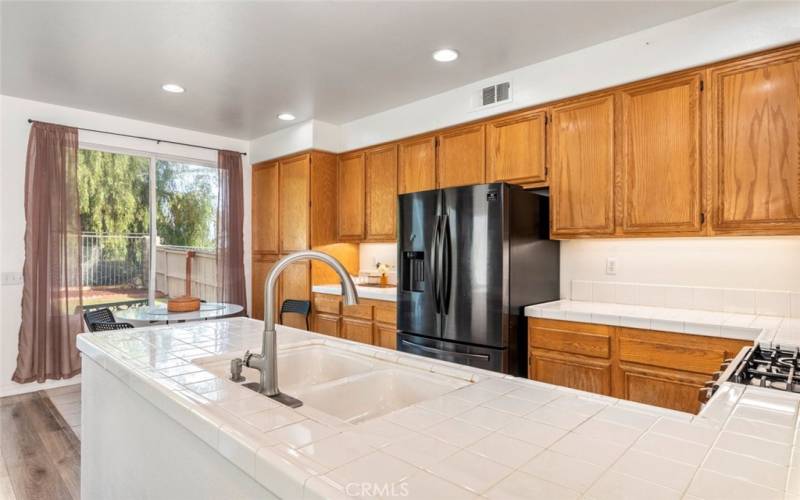 
This kitchen features abundant cabinet space, providing plenty of storage for all your culinary essentials and keeping the area organized and clutter-free.