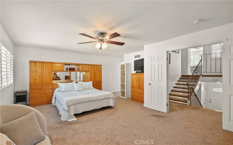 Double door entry, newer, deluxe carpet, and plantation shutters in primary bedroom