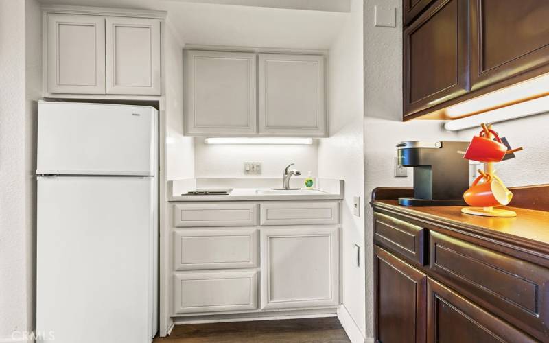 Kitchen with cooktop and refrigerator