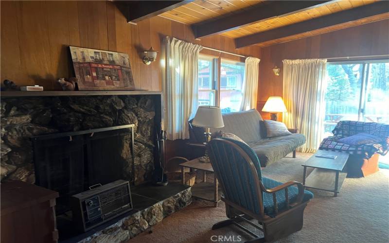 Living room with wood burning fireplace.