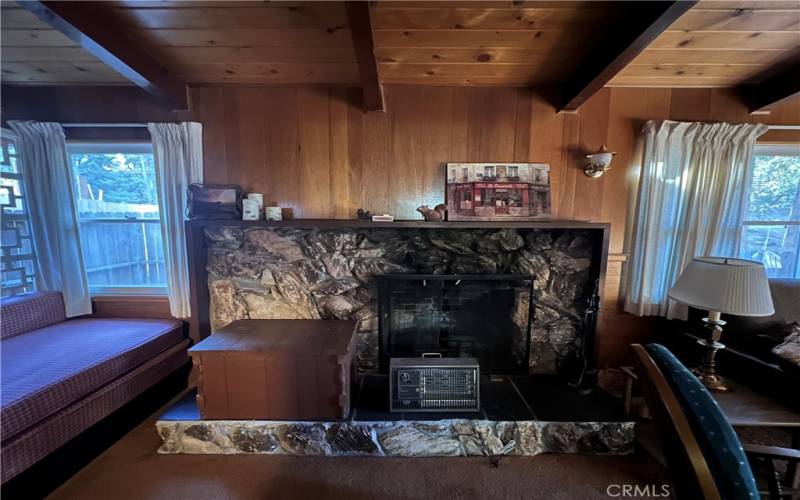 Living room with wood burning fireplace.