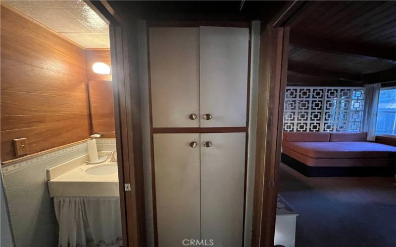 Bathroom with linen cabinet.