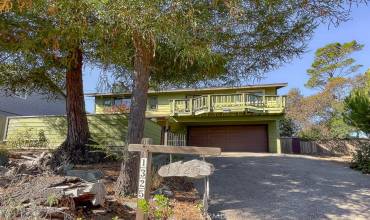 Cambria hidden retreat on a quiet road with three bedrooms and two bathrooms and an attached two car garage.