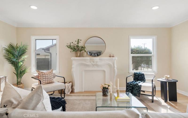 Living room with original faux fireplace and mantle.