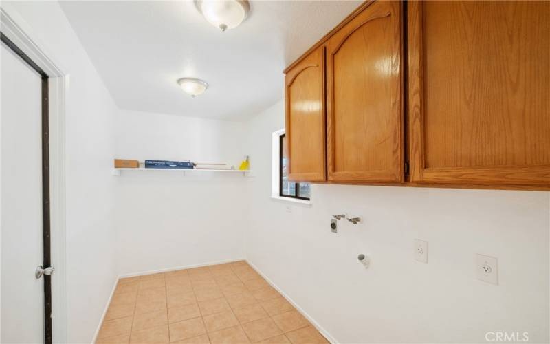 Oversized, indoor laundry room with storage!