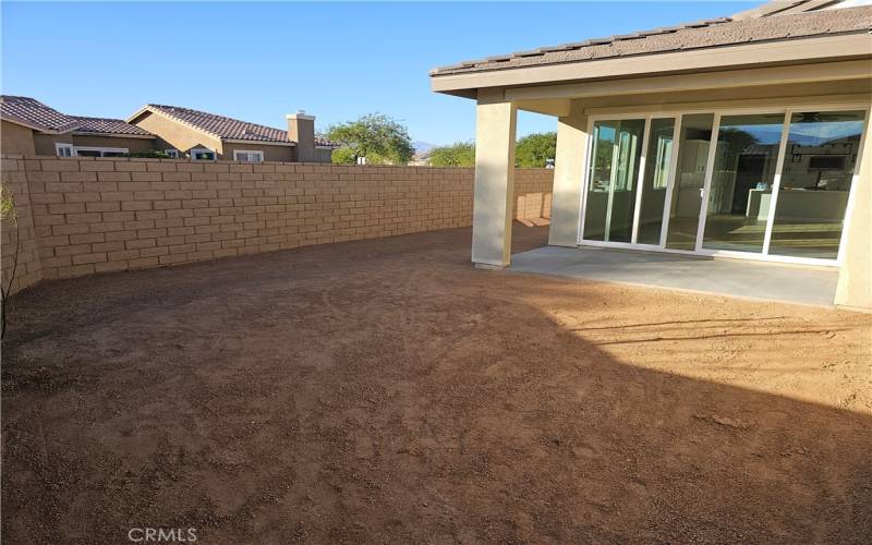 Backyard with covered patio.