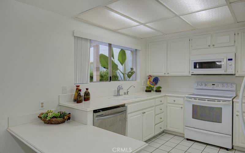 Kitchen is nearly original and includes freestanding range, microwave, dishwasher and refrigerator.