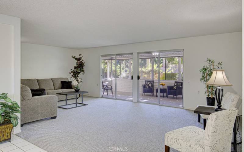 Spacious living room opens to the enclosed patio.