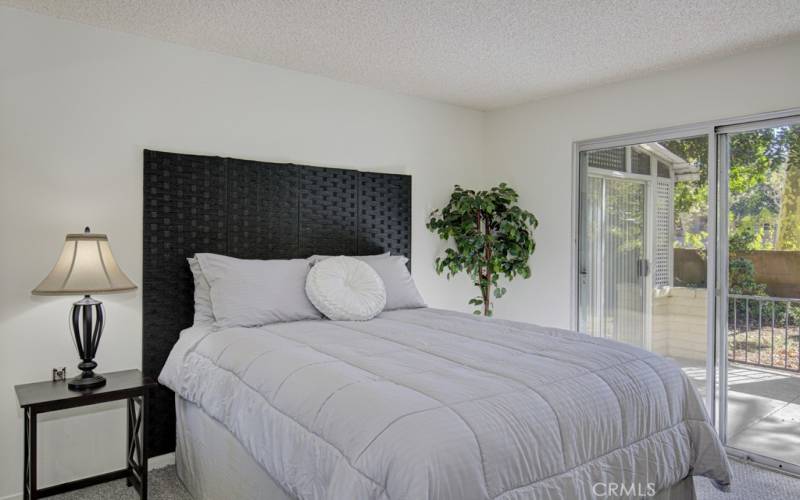 Guest bedroom has a sliding door to the patio.