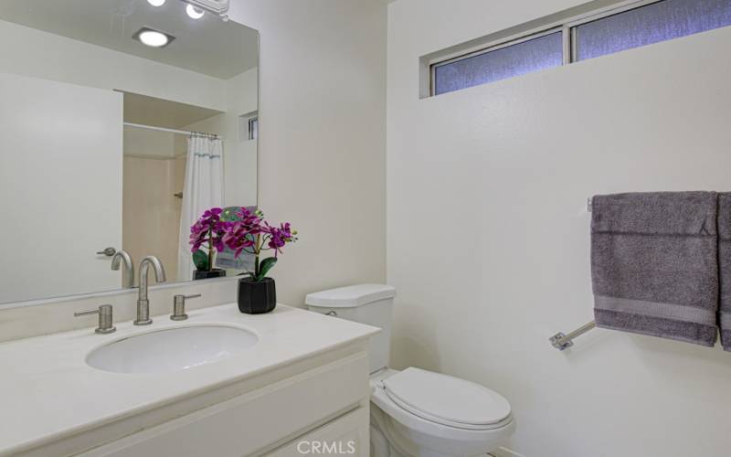 Guest bathroom has a nice vanity and a window.