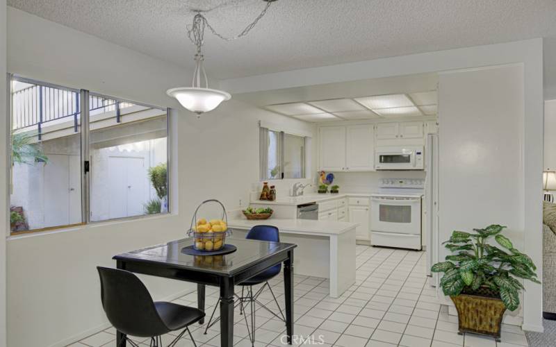 Pretty kitchen and dining area overlooks the front patio.