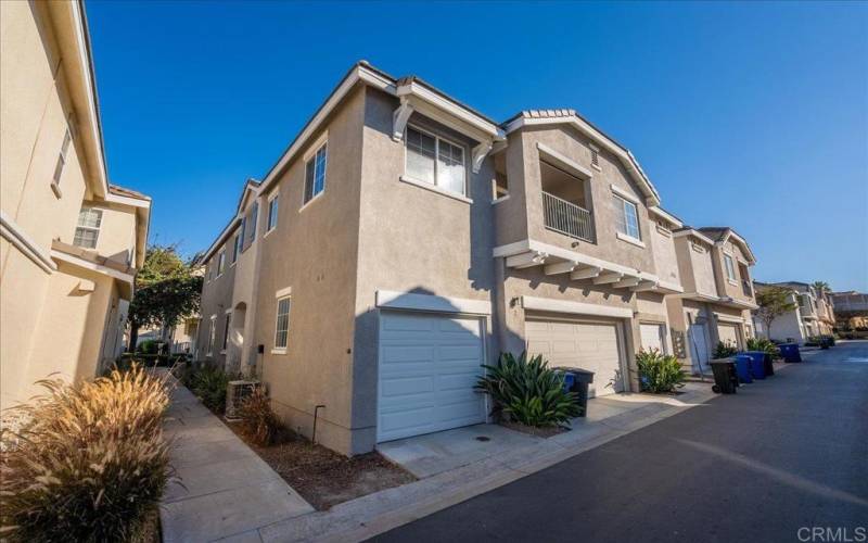 Outside view of private balcony and attached 1 car garage