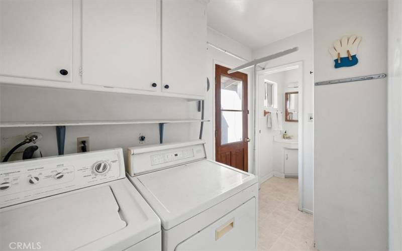 Laundry room with exit to side yard.