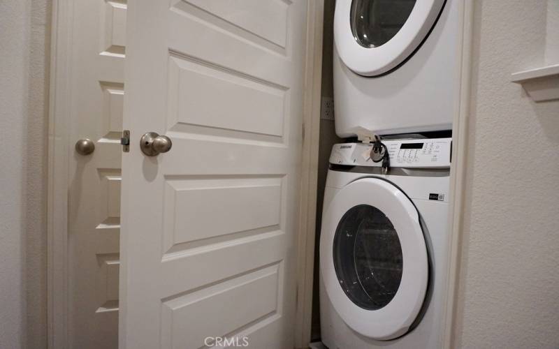 Laundry machines on the hallway of the bedrooms area