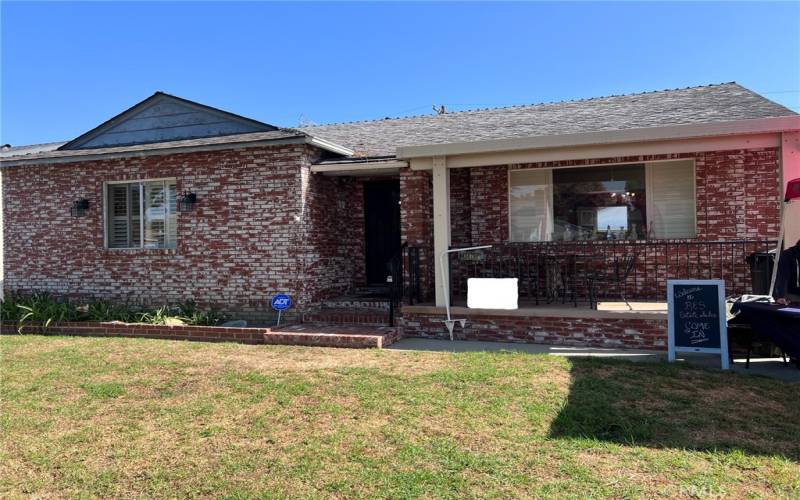 Brick house with yard and porch