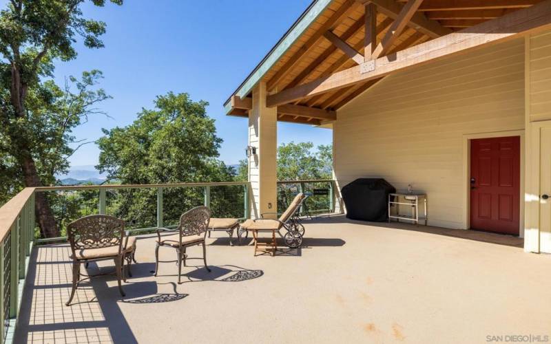 The spacious deck set in the trees with views.