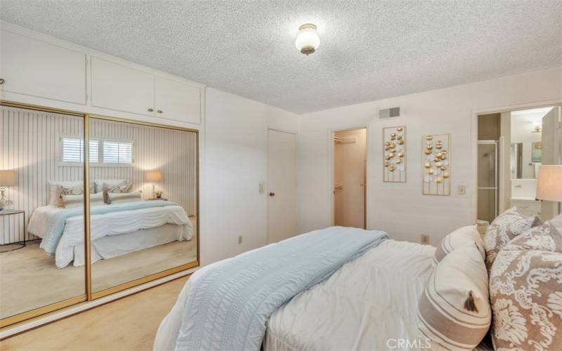 Primary bedroom offers two closets and bathroom